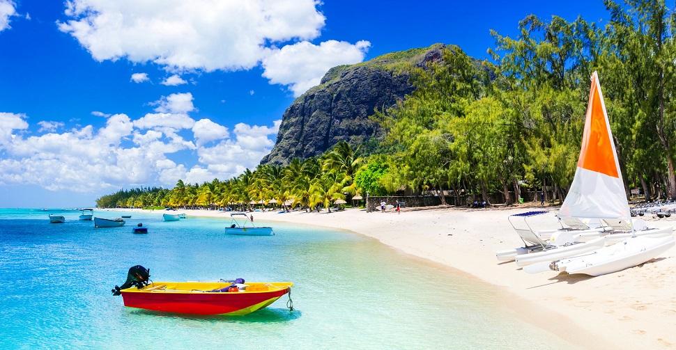 White sand beach with turquoise water and boats in Mauritius