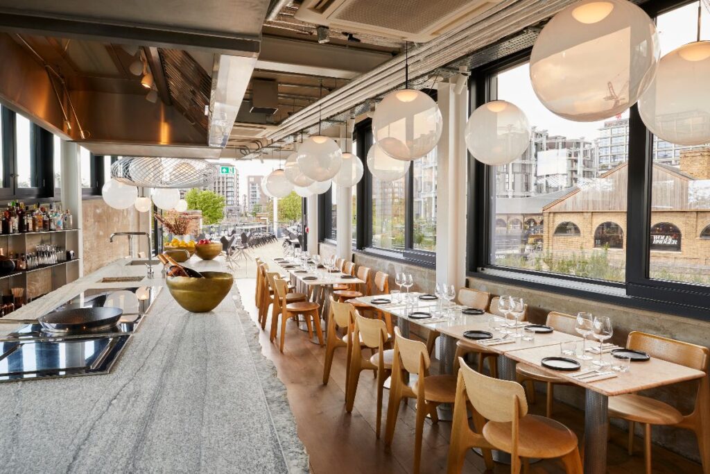 Industrial restaurant setting with open plan terrace ready for a summer dinner party