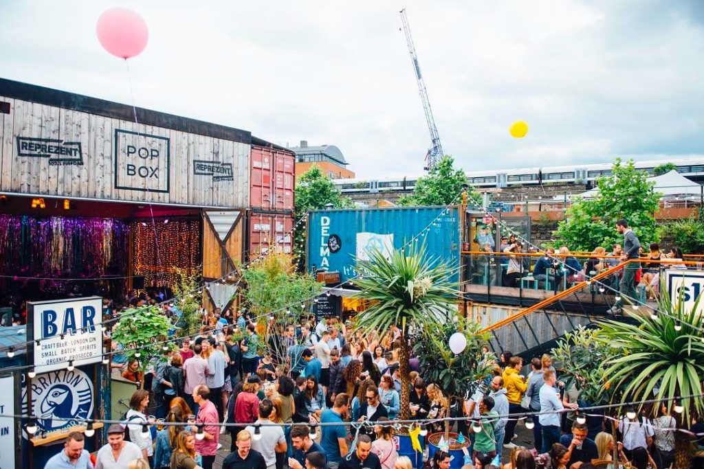 Summer party at The Pop Brixton container food market with people