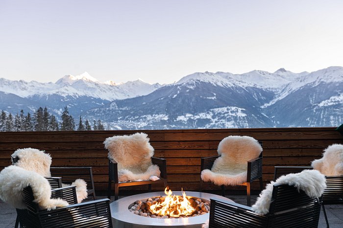 Outdoor fire pit with fur lined seats and mountain views