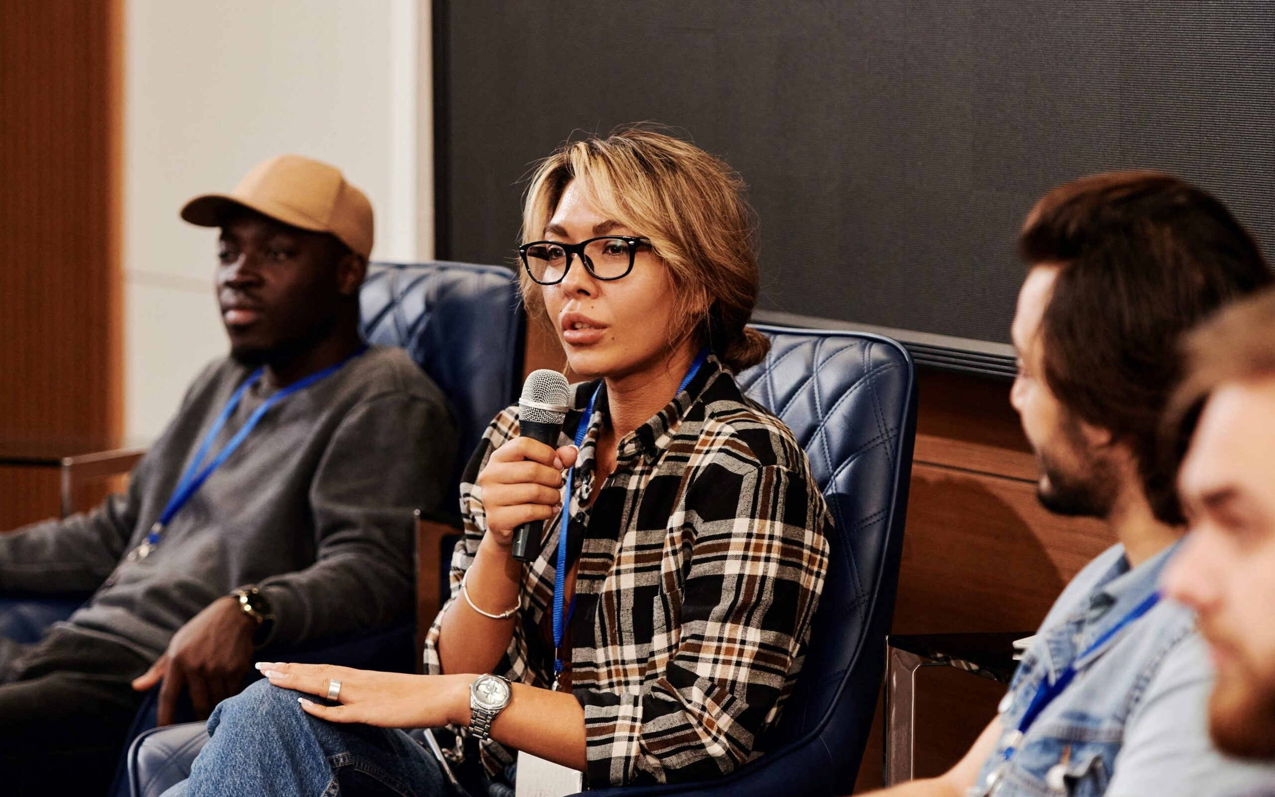 A female motivational speaker speaking on microphone